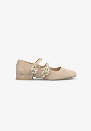 Ballerines en daim beige avec deux boucles décoratives ornées de gemmes transparentes, petit talon carré, design à bout en amande et texture lisse.