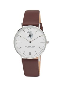 Orologio rotondo con quadrante bianco, hardware argentato, cinturino in pelle marrone e grafica di un giocatore di polo. Il display include indici delle ore e il numero sei.