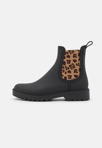 Black rubber Chelsea boots with a leopard print elastic side panel, textured comfort sole, and pull tab on the heel for easy wear.