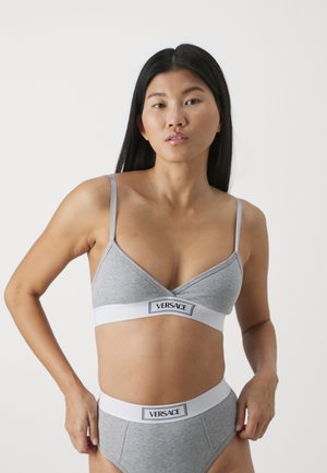 Grijze geribbelde bralette met dunne bandjes, voorzien van een witte elastische band met het label "VERSACE." Inclusief bijpassende grijze high-waisted onderbroek.