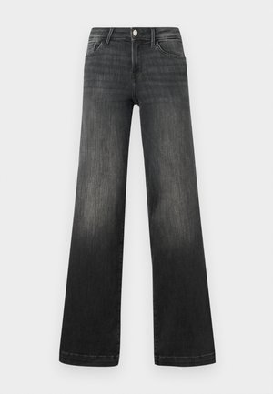 Mustad laiad teksapüksid pleekinud denimis, millel on ees taskud, nööp sulgemine ja peen õmblusdetail pükste õmblustel.