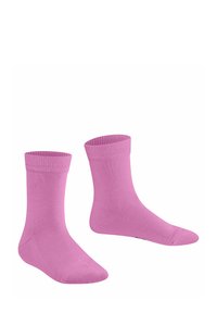 Due calzini rosa sono esposti affiancati, con un bordo a coste e una texture liscia, mettendo in evidenza il loro colore vivace e il design semplice.