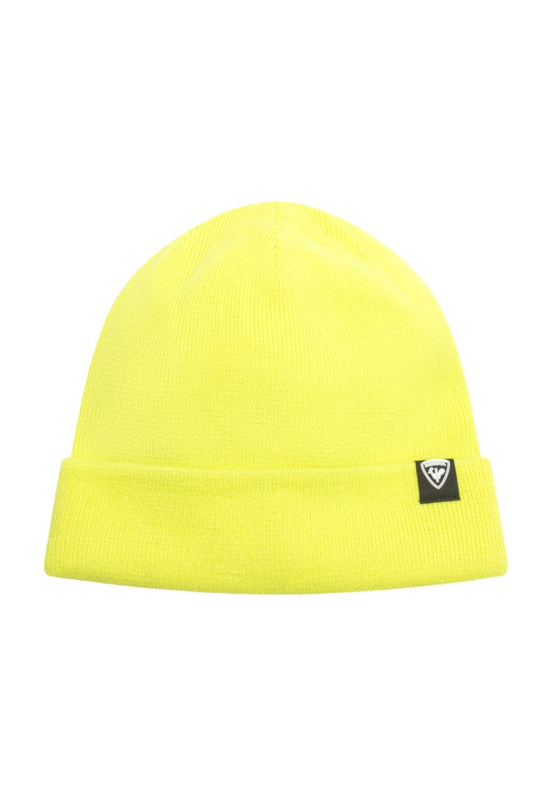 Stickad gul mössa med uppvikt kant, försedd med en liten svart logotyp-patch på sidan. Mjuk textur och stretchigt tyg.