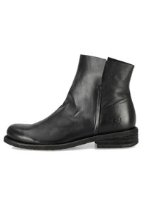 Bottines en cuir noir avec un bout rond, des coutures discrètes et un petit talon en hauteur empilée. Elles présentent une texture lisse et un design minimaliste.