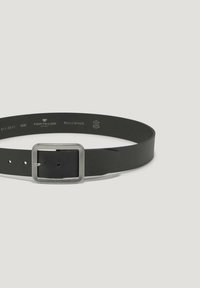 Black belt made of textured material with a silver square buckle. Features multiple hole adjustments and branded engraving on buckle.