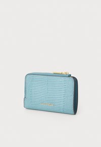 Blue textured leather wallet with a golden logo, zip closure, and contrasting dark blue edges. Compact rectangular shape with a smooth finish.