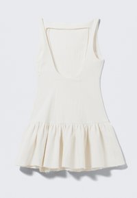 Light beige sleeveless dress with a scoop neck, a textured finish, and a flared, ruffled hem with raw edges. Features a side zipper.