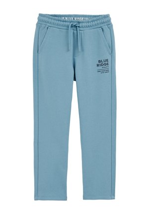 Pantalones de chándal de color azul claro, hechos de una tela suave, con una cinturilla elástica, dos bolsillos laterales y un logo impreso en negro cerca de la cadera.