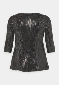 Black sequined top with three-quarter sleeves, round neckline, and flared hem. Features a shimmering, textured pattern throughout.