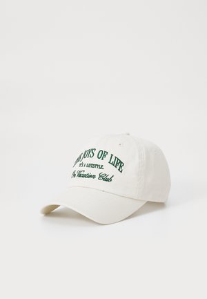 Casquette en coton blanc avec texte brodé vert : « Les Joies de la Vie, C'est un Style de Vie, Au Club Vacance » et une visière incurvée.