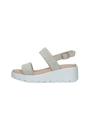 Sandalo con zeppa con tomaia intrecciata in beige chiaro, cinturino alla caviglia regolabile e suola piattaforma bianca con fondo testurizzato per una migliore aderenza.