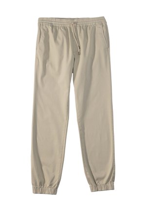 Beige Baumwoll-Jogginghose mit elastischem Bund, Kordelzug, Seitentaschen und schmal zulaufenden Bündchen. Glatte Textur ohne sichtbare Muster.