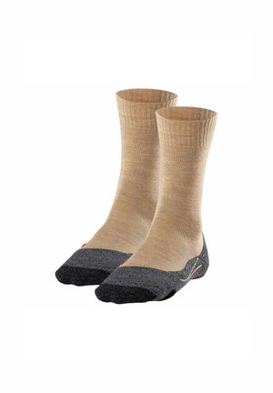 Beige Socken mit Rippendesign, die eine dunkelgraue Zehe und Ferse haben. Aus einem strukturierten Material gefertigt für Langlebigkeit und Komfort.