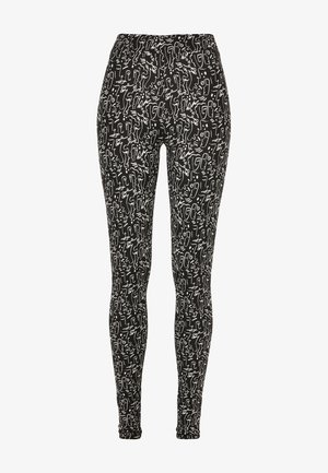 Zwarte leggings met een wit abstract patroon waarin verschillende lijntekeningen zijn verwerkt. Elastische tailleband; rekbare stof met een gladde textuur.