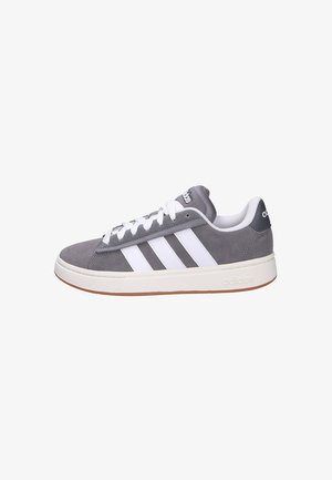 Gray suede Adidas sneaker with white stripes, white laces, padded collar, and gum rubber sole shown in side profile.