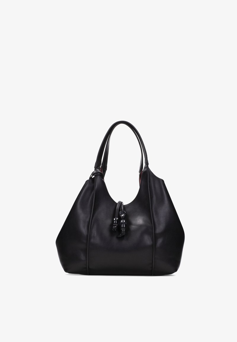 Sac à main en cuir noir avec doubles anses et tassels décoratifs suspendus à l'avant, présenté sur un fond blanc.