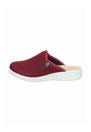 Red mesh slip-on slipper with white sole and small black Fly Flot logo tag on side, designed for indoor comfort.