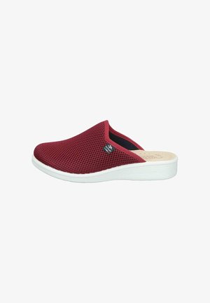 Red mesh slip-on slipper with white sole and small black Fly Flot logo tag on side, designed for indoor comfort.