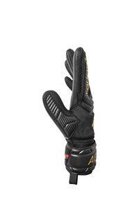 Black goalkeeper glove with textured grip, reinforced palm and fingers, mesh backing, and elastic wrist strap featuring red and gold accents.