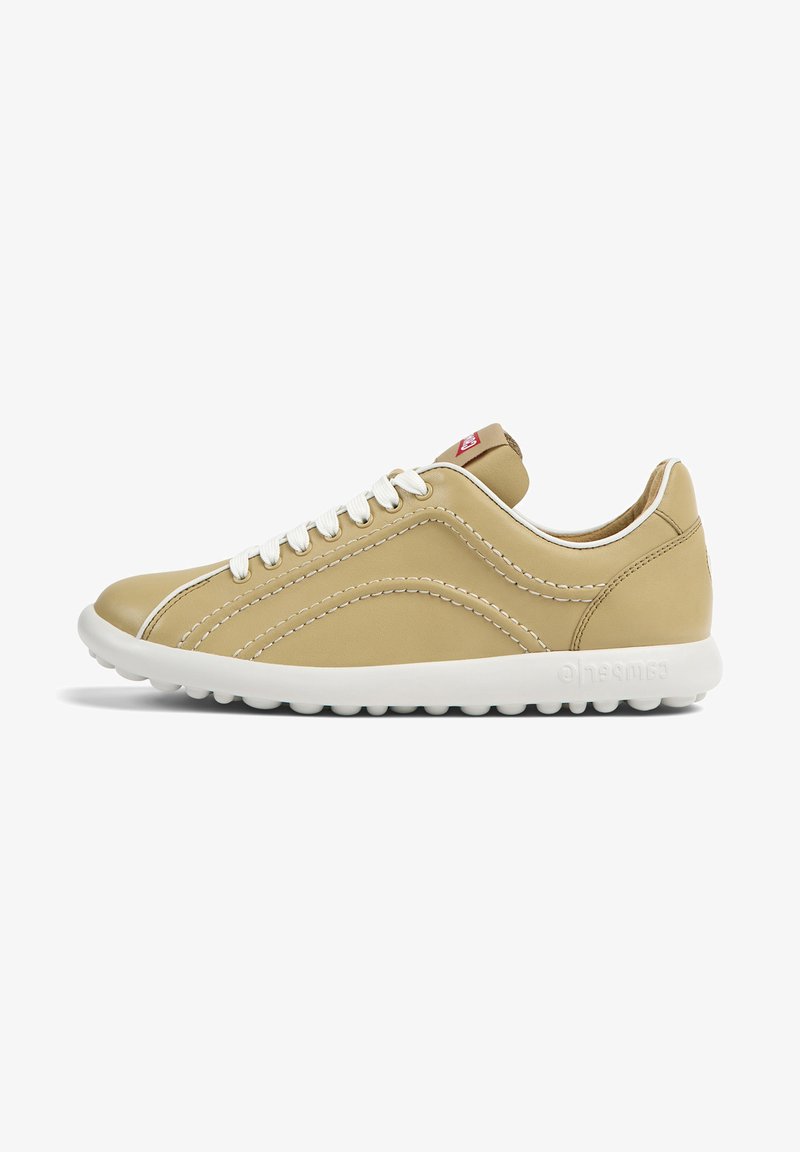 Beige leather sneaker with white rubber sole, contrasting stitching, and round laces; features a tab with logo on the heel.