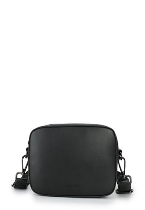 Black synthetic crossbody bag with a rectangular shape. Features smooth texture, adjustable strap, and embossed brand logo on the front.