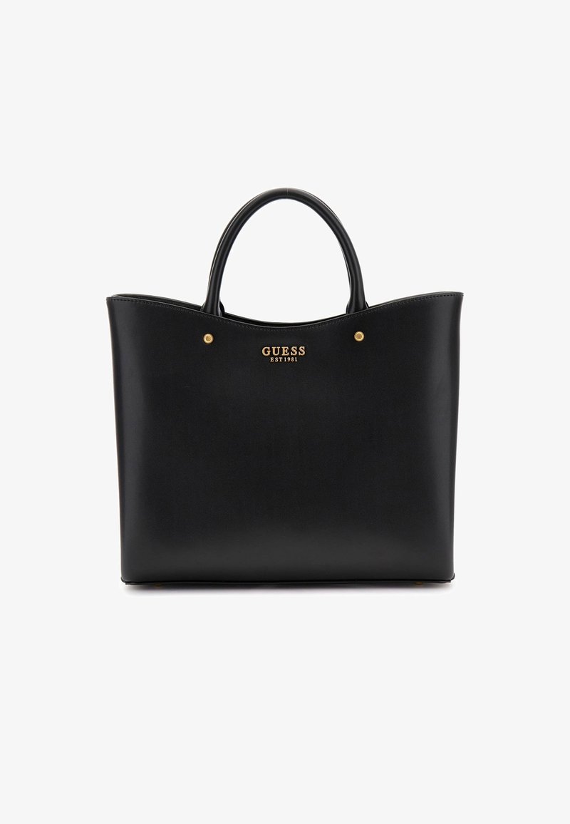 Sac à main Guess en cuir noir avec deux poignées et logo doré portant le texte ""GUESS EST 1981"" au centre devant.