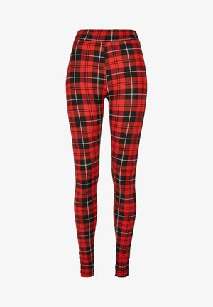 Leggings à carreaux rouges présentant un motif à damiers noir et blanc. Fabriqués en matière extensible avec un design taille haute.