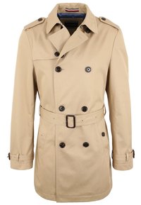 Beżowy trencz z podwójnymi guzikami, paskiem w talii i naramiennikami. Posiada klasyczny kołnierz oraz mankiety z akcentami guzików.