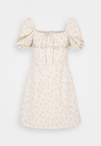 Robe à manches bouffantes en tissu léger couleur crème avec de petits motifs floraux roses. Encolure carrée avec un détail de lien ajustable à l'avant. Silhouette évasée.