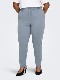 Light blue stretchy trousers with a drawstring waist, side pockets, and tapered legs, paired with black pointed heels.