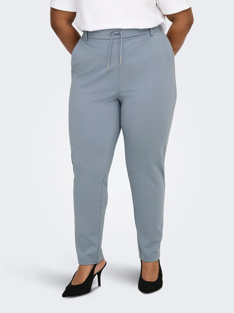 Light blue stretchy trousers with a drawstring waist, side pockets, and tapered legs, paired with black pointed heels.