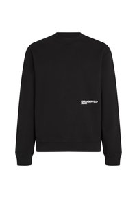 Must elektrood ripsiga puuvillasegune must sviiter, millel on ringkäelus ja mansetid. Vasakul küljel, hemmi lähedal, on valge brändingu element.