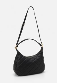 Black quilted handbag made of textured leather. Features a shoulder strap and gold-tone hardware. Zipper closure along the top.