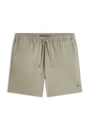 Világos bézs színű férfi fürdőnadrág, rugalmas derékrésszel, húzózsinórral, oldalzsebekkel és egy kis piros, fehér, kék logóval a bal lábszár szegélyén.