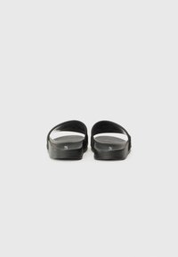 Black open-toe slide sandals featuring a smooth, matte finish, two wide straps, and a cushioned footbed for comfort. Minimalist design with no embellishments.