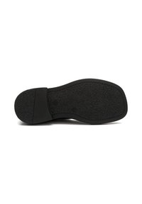 Suela de zapato negra con superficie de goma texturizada, ligero tacón y bordes suaves. Presenta un logo y un agarre con patrón. Sin marcas visibles.