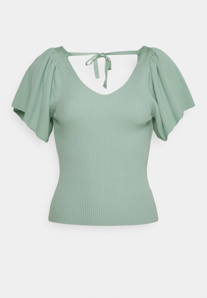 Top en maille côtelée vert clair avec manches courtes bouffantes et fermeture par lien au dos sous un décolleté en V profond.