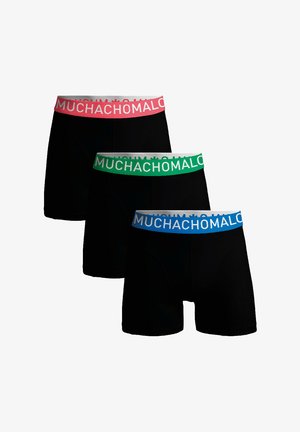 Sorte boxer shorts med elastisk talje i pink, grøn og blå med teksten "MUCHACHO" i hvid over taljerne.