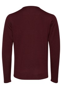 Chemise à manches longues couleur marron, vue de dos, avec un col rond simple et sans motifs ni logos visibles.