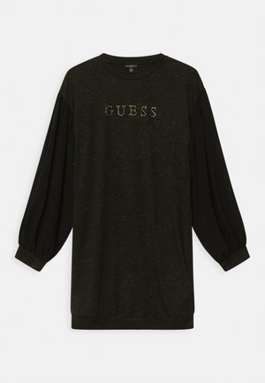 Czarna sukienka z długim rękawem i bufkami oraz logo "GUESS" z małych złotych ćwieków na klatce piersiowej, okrągły dekolt.