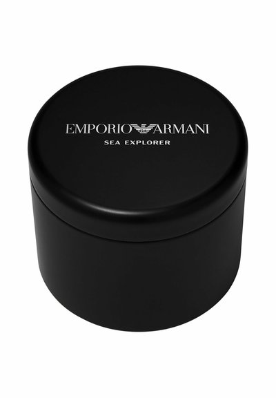 Zwarte cilindervormige doos met zilveren "Emporio Armani Sea Explorer"-logo op het deksel, gebruikt voor het verpakken of bewaren van luxe artikelen.