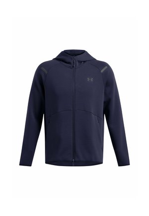 Marineblauer Zip-Hoodie aus weichem Stoff. Verfügt über eine Kapuze, Fronttaschen und Schulterakzente. Dezentes Logo auf der Brust.