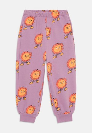 Purple children's pants with orange cartoon sunflowers wearing boots printed all over, elastic waistband, and ribbed cuffs.
