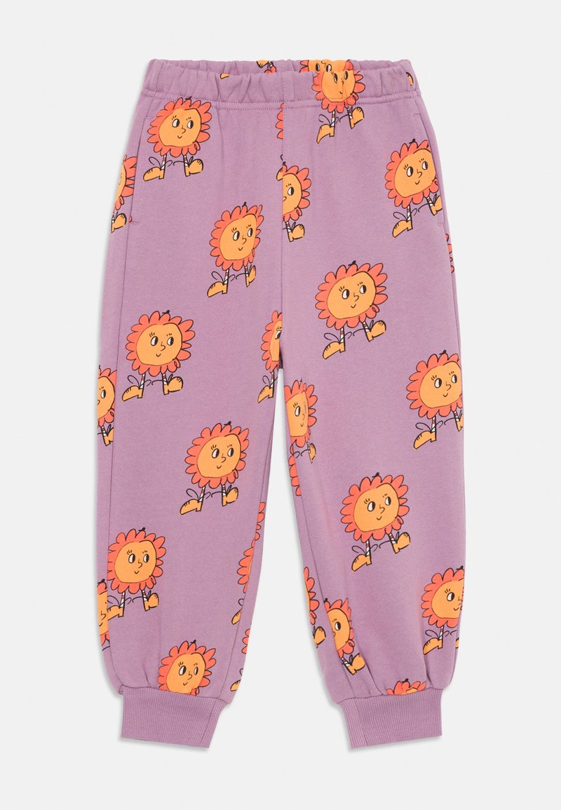 Vijolične otroške hlače z natisnjenimi oranžnimi risanimi sončnicami, oblečenimi v škornje, po celotni površini, z elastičnim pasom in rebrastimi manšeti.