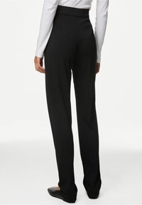 Pantaloni neri a vita alta realizzati in un tessuto morbido. Design a gamba dritta con retro pulito, senza tasche visibili e orli rifiniti.