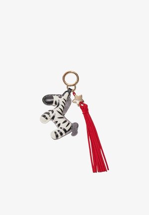 Keychain with a black and white zebra figure, a gold star charm, and a long red tassel hanging from a gold ring.