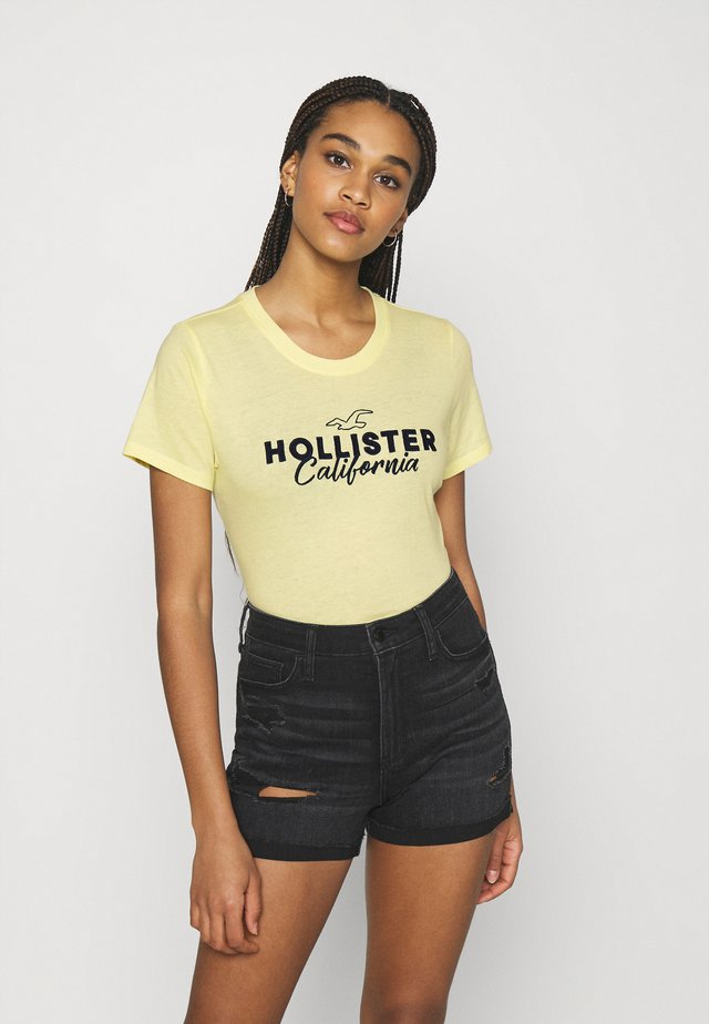 TECH CORE - Print T-shirt - light soft yellow