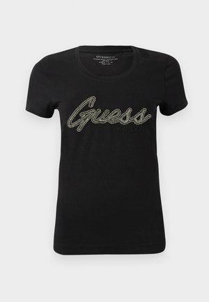 Svart bomulls T-skjorte med korte ermer og rund hals, med en stor, glitrende "Guess" logo i metalltråd over fronten.
