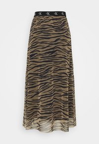 Kjol i knälängd av ett genomskinligt material, med ett tigerrandigt mönster i brunt och svart. Elastisk svart midja med logodetalj.