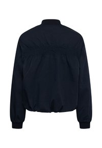 Veste noire à manches longues avec poignets élastiques, détail froncé sur le haut du dos et col côtelé, vue de dos.